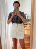 Mini gonna bianca con bottoni
