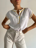 Blusa bianca profili gialli