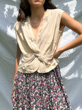 Top beige con incrocio