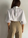 Camicia crop con bottoni dietro